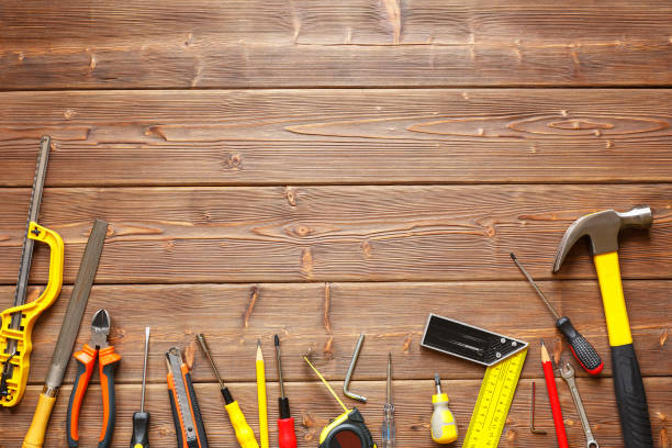 a set of hand tools on a wooden background. the concept of repair work. copy space - herramienta triangular fotografías e imágenes de stock
