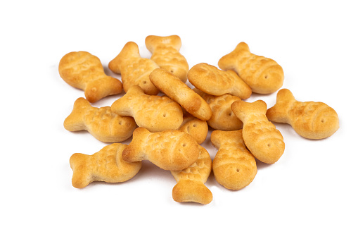 Yellow fish crackers on isolated white background.