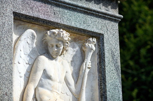 Ancient statue of an guardian angel isolated on white background. Copy space for design.