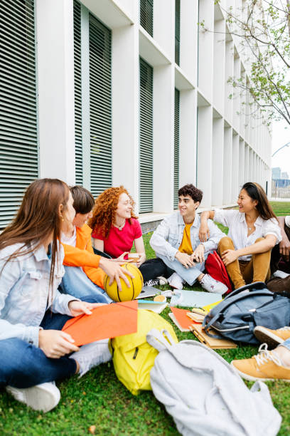 Students sitting on the grass of the campus
