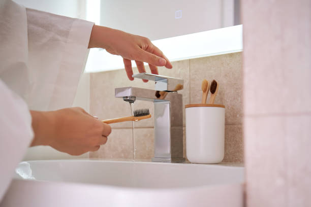 istock Women's hands under running water in the bathroom. Morning routine. 2096037265