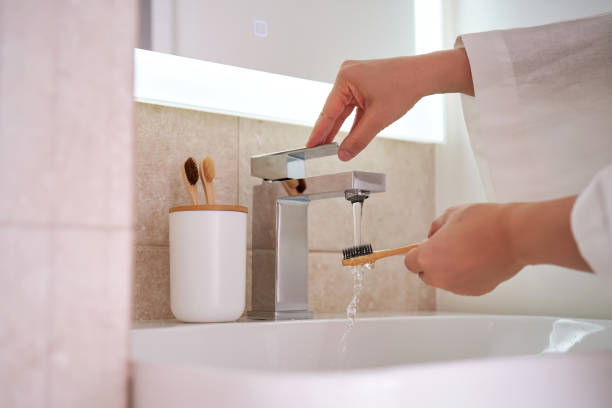 istock Women's hands under running water in the bathroom. Morning routine. 2096043105