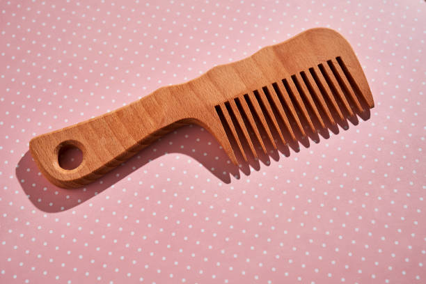istock Wooden comb on a pink polka dot background. 2096067940