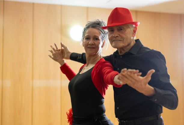 elderly senior couple dancing in retirement dance class