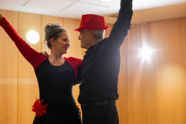 istock senior couple looking at each other posing for dance class in dance workshop for retirees 2096091274