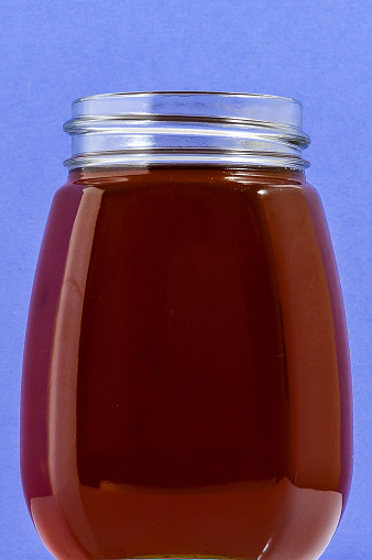 One Full Honey Jar on a Colored Background