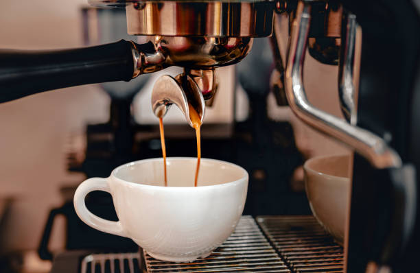 istock Coffee extraction from the coffee machine with a portafilter pouring coffee into a cup,Espresso poruing from coffee machine at coffee shop 2096114815