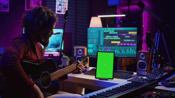 istock Male artist learning to play guitar on online lesson tutorial 2096118982