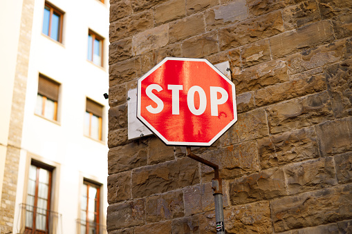 Stop sign up against an old brick wall