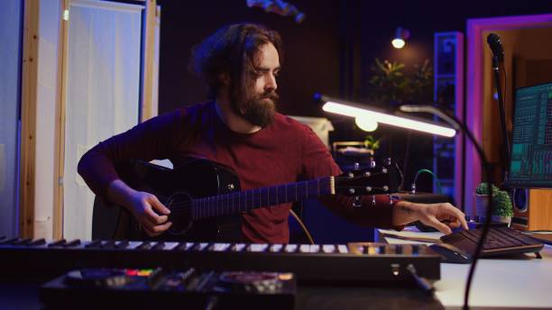 istock Artist working with daw software at his home studio to record new music 2096129437