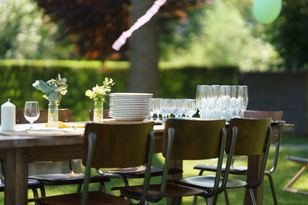 istock Set table at summer garden party, empty plates and glasses. Table setting with glasses, lemonade, delicate floral and paper decoration. 2096131577