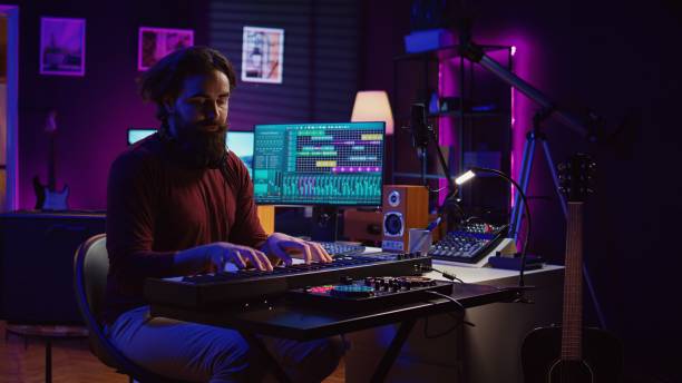 istock Sound engineer playing electronic piano keyboard and recording sounds 2096135774