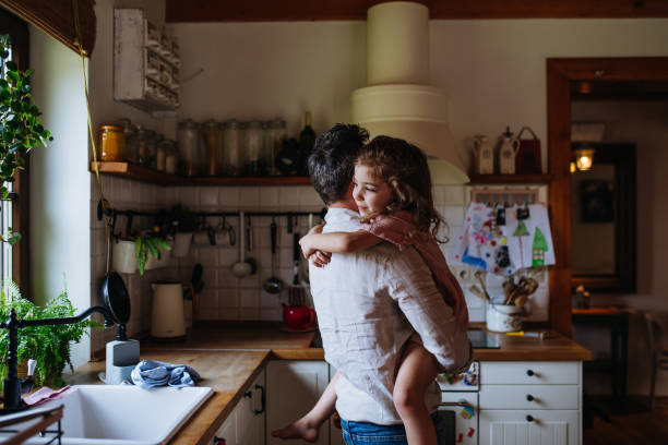 istock Daughter hugging father lovingly, looking at camera, smiling with gap-toothed grin. Unconditional paternal love, Father's Day concept. 2096137927