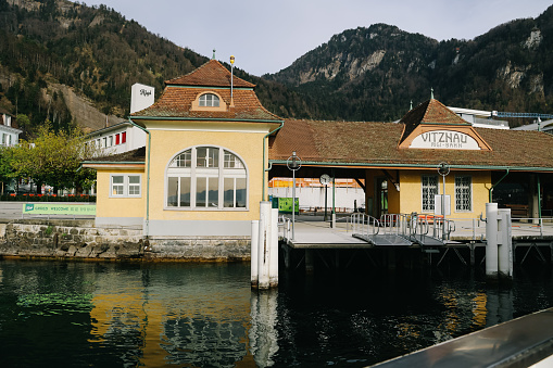 Vitznau, Switzerland - JApril 12, 2022: The Vitznau ferry terminal is popular tourist destination and start water cruise scenic view of mountains on lake lucerne, Switzerland.
