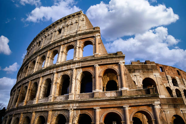 Roman Colosseum with bright blue sky and clouds. Rome, Italy