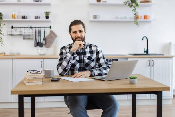 istock Business person posing with pen, documents and portable computer. 2096141177