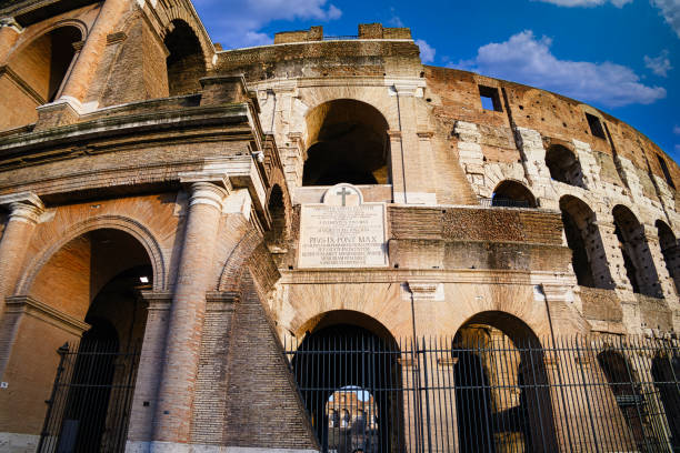 Roman Colosseum with bright blue sky and clouds. Rome, Italy