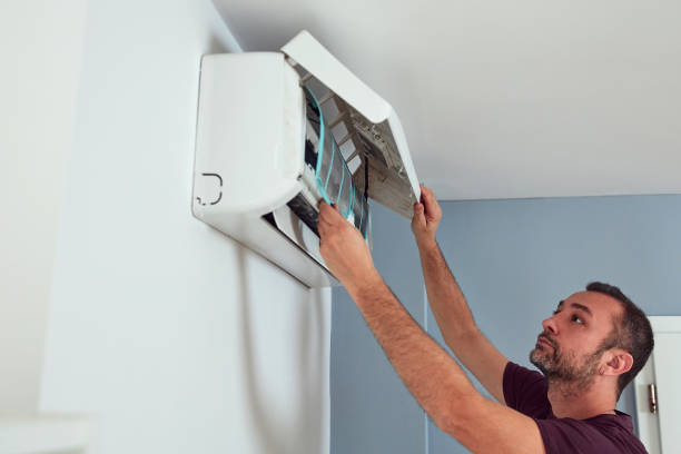istock Man cleaning and maintaining air condition unit. 2096151859