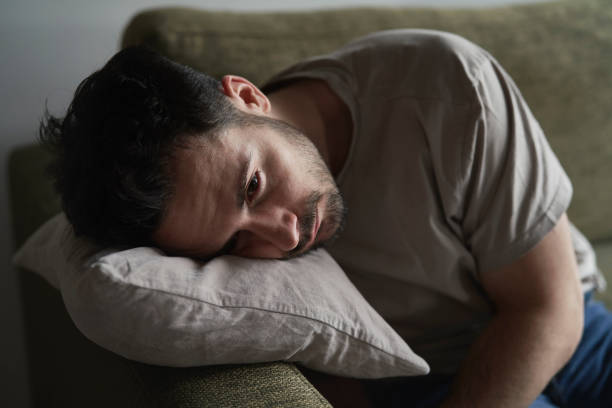istock Close up of thoughtful man with head on pillow 2096160311