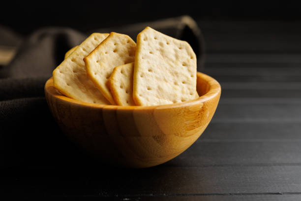 istock Salted Crackers in bowl Against a Dark Background 2096184967