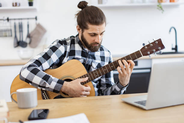 istock Bearded adult posing with guitar while enjoying pleasant pastime at home. 2096203042