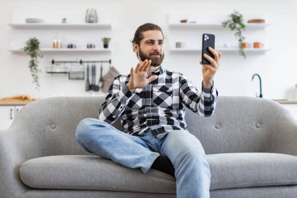 istock Joyous businessman greeting video call participants during working time. 2096203628