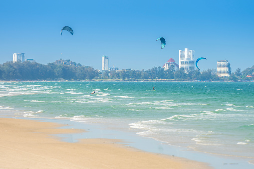 People make kites and windsurf at Hua Hin beach, Thailand.