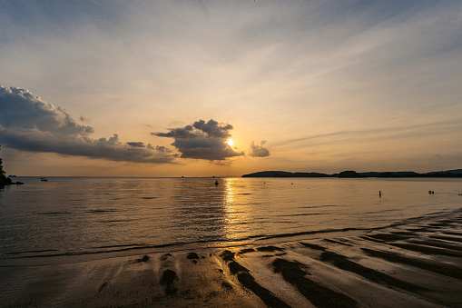 Beautiful sunset on the Ao Nang beach on the Andaman sea in Thailand.