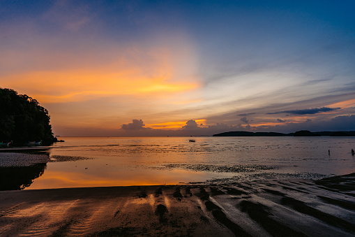 Beautiful sunset on the Ao Nang beach on the Andaman sea in Thailand.