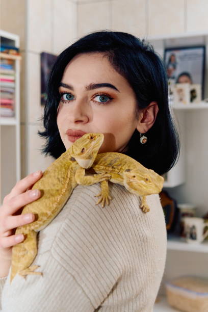 istock Beautiful Woman Posing with Her Two Adorable Bearded Dragon Pets 2096218865