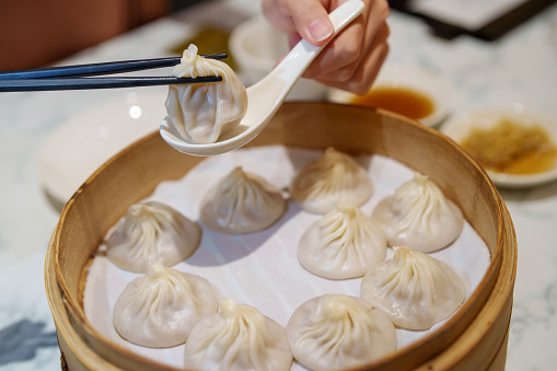 Xiaolongbao is a type of Chinese steamed bun (baozi) from the Jiangnan region, especially associated with Shanghai and Wuxi. It is traditionally filled with pork and a rich broth, although variations with other fillings exist.