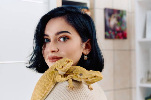 istock Beautiful Woman Posing with Her Two Adorable Bearded Dragon Pets 2096249389
