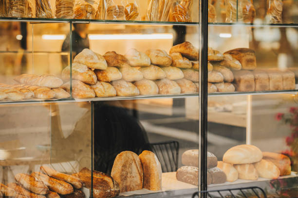 istock Bakery display case with variety of breads and pastries. Blurred view through store window 2096255748