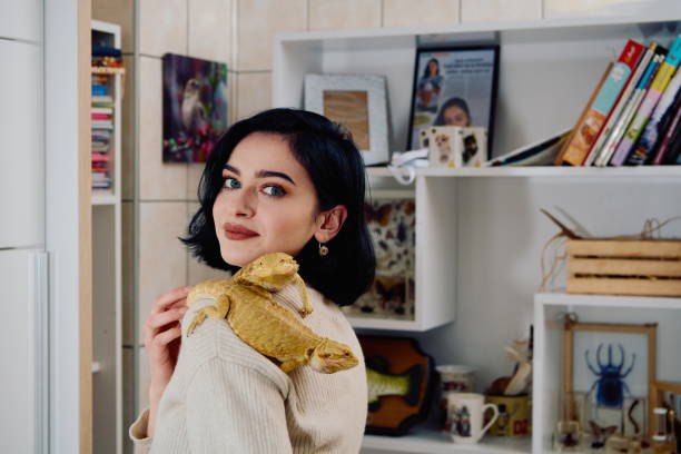 istock Beautiful Woman Posing with Her Two Adorable Bearded Dragon Pets 2096258637