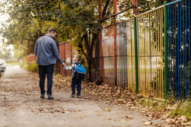 istock Rear view of a father and son going in kindergarten. 2096264740