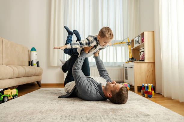 istock A father and son are playing airplane at home. 2096267208