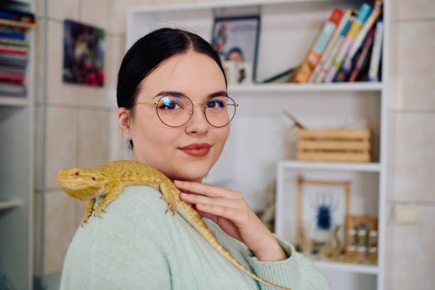 istock Beautiful Woman Posing with Her Adorable Bearded Dragon Pets 2096280534