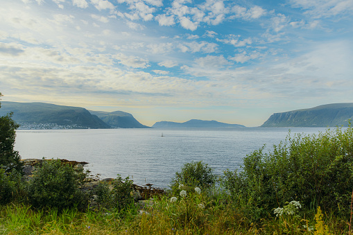 Dramatic view of summer landscape with beautiful seashore with background view of Sunnmore Alps in Western Norway, Scandinavia