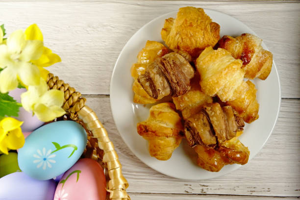 istock Easter Eggs in Wicker Basket and Croissants table top view copy space stock photo 2096293065
