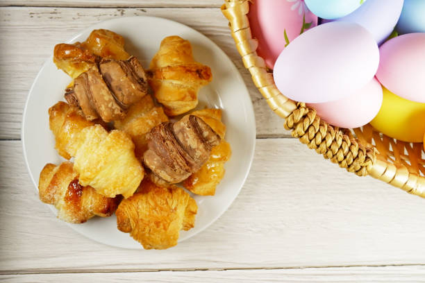 istock Easter Eggs in Wicker Basket and Croissants table top view copy space stock photo 2096293797