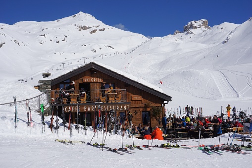 Valtournenche, Italy - 13 March 2024: Skiers are relaxing in the lunchtime sunshine at a mountain restaurant in the Valtournenche sector of the Cervinia ski area.