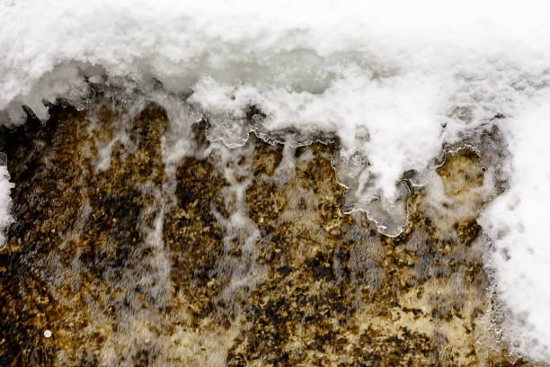 A small snow covered waterfall somewhere far in the mountain forest.2019
