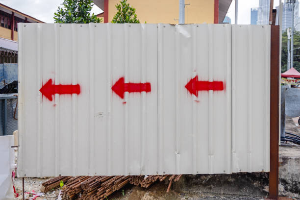 Three red arrows painted on a metal fence outside a construction site in the Malaysian capital Kuala Lumpur