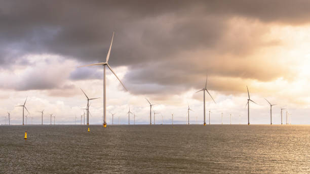 istock Offshore Windfarm at sea under cloudy sky 2096326486