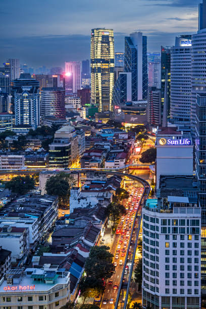Kuala Lumpur, Malaysia - January 4th 2024:  Street with lights and a skyline with tall buildings in the center of the Malaysian capital