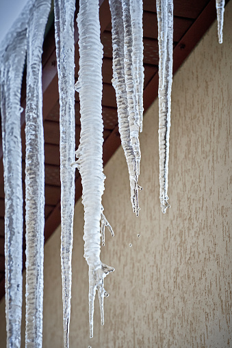 Beautiful icicles cascading from a roof and providing a view