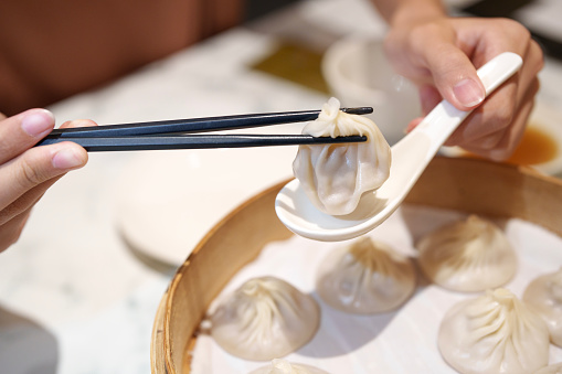 Xiaolongbao is a type of Chinese steamed bun (baozi) from the Jiangnan region, especially associated with Shanghai and Wuxi. It is traditionally filled with pork and a rich broth, although variations with other fillings exist.
