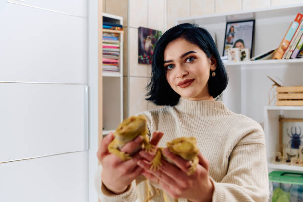 Beautiful Woman Posing with Her Two Adorable Bearded Dragon Pets