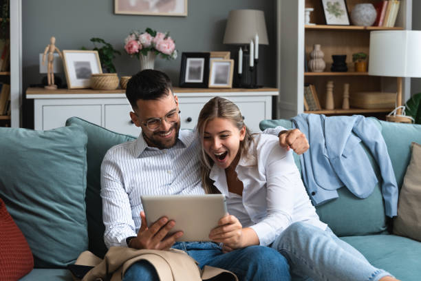 istock Young happy business people using digital tablet surfing the net searching for appropriate campervan for vacation travel. Business owners sold their work for adventure and camping. Freedom concept 2096377651