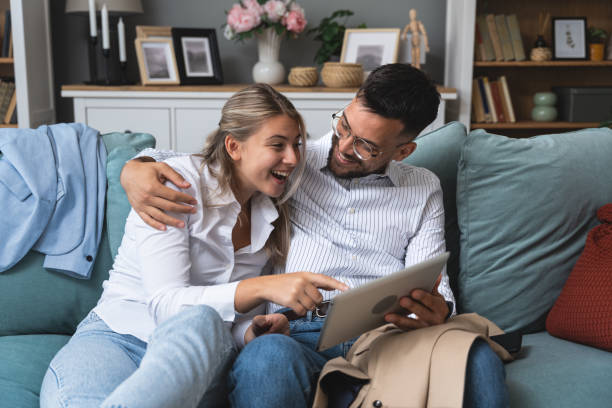 istock Young happy business people using digital tablet surfing the net searching for appropriate campervan for vacation travel. Business owners sold their work for adventure and camping. Freedom concept 2096378165